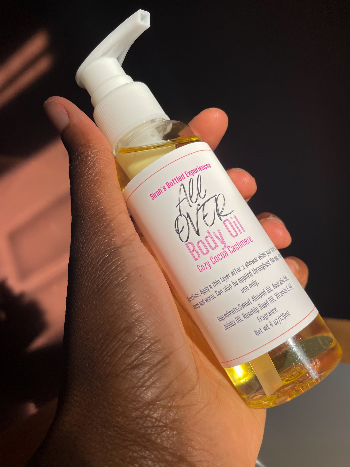 hand model holding all over body oil 